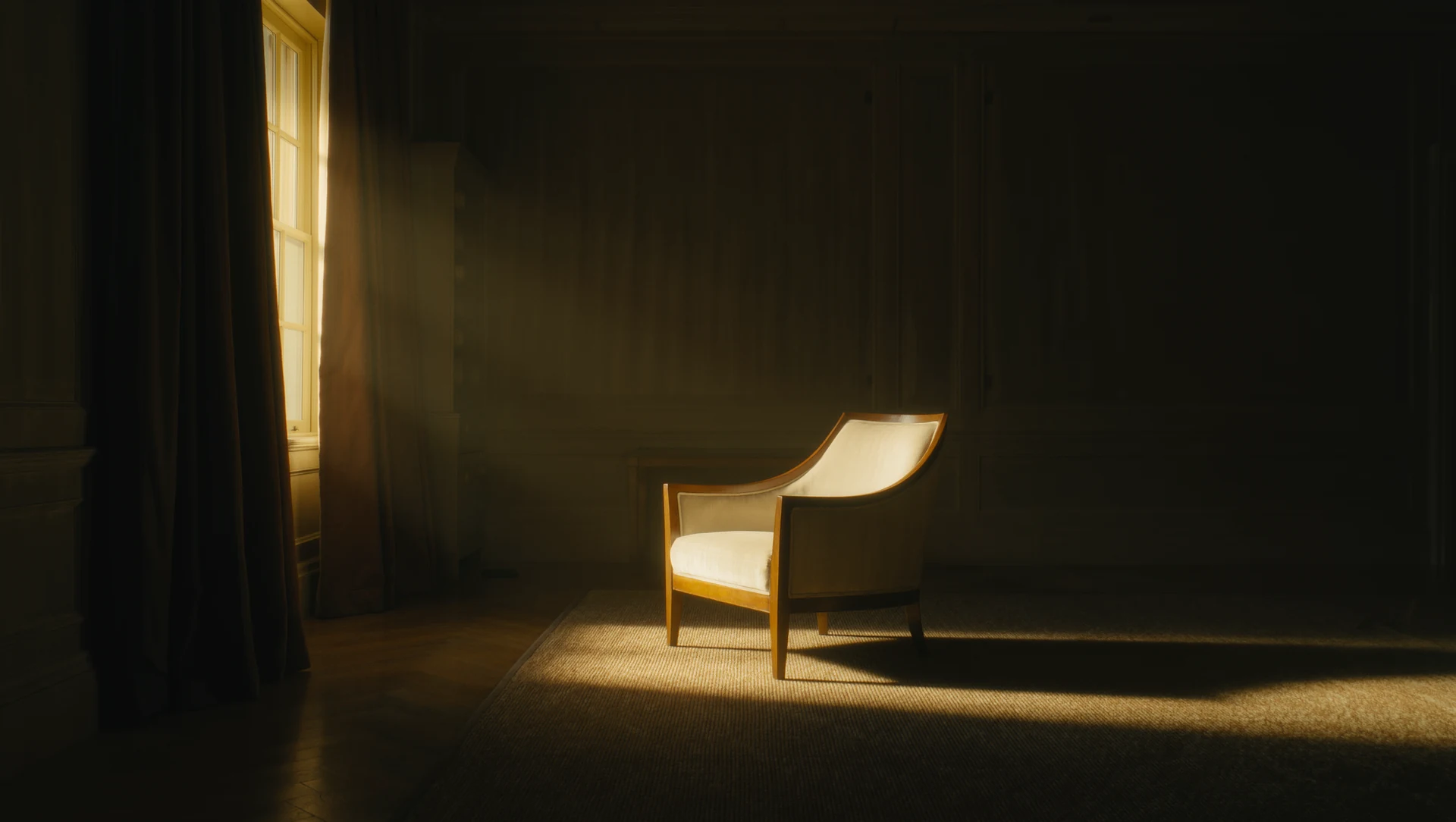 A single window in a dim room with heavy curtains drawn slightly open, a warm shaft of light falling across an empty armchair