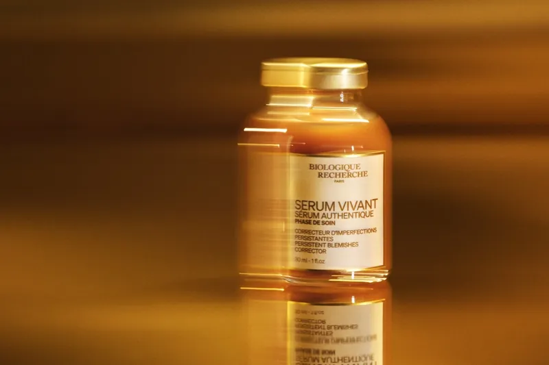 Bottle of Sérum Vivant by Biologique Recherche with amber serum in warm light