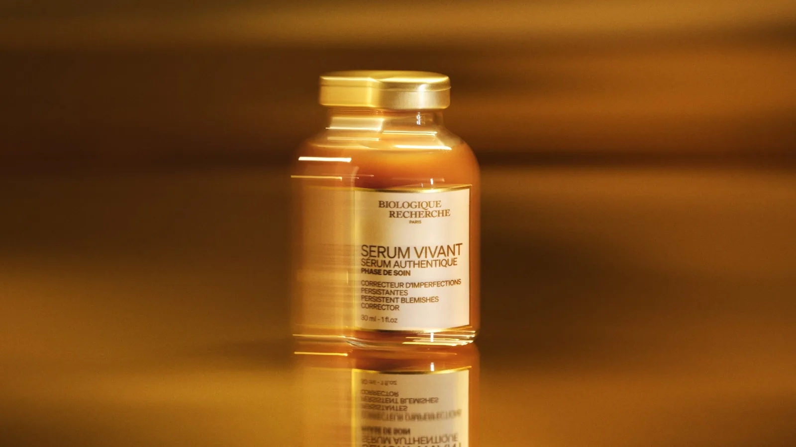 Bottle of Sérum Vivant by Biologique Recherche with amber serum in warm light