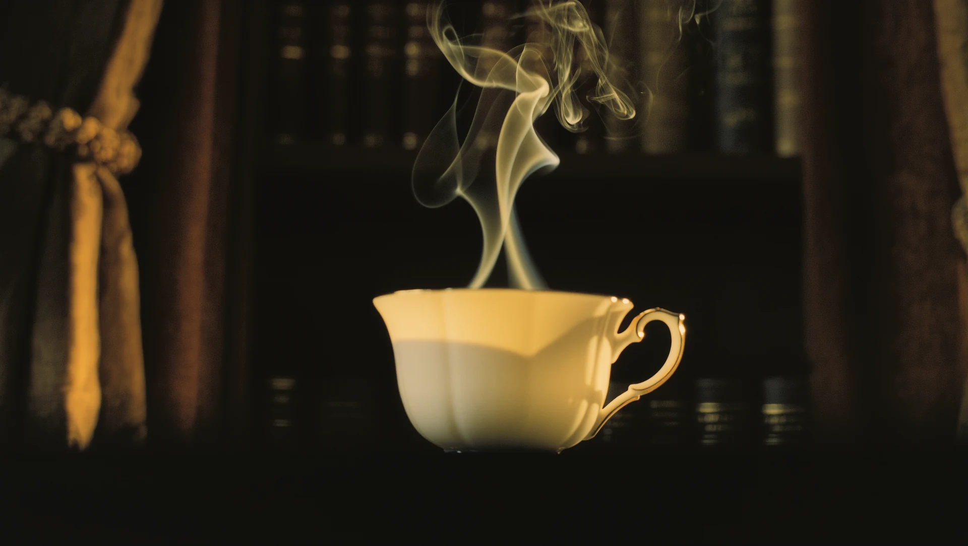 Close-up of steam curling from a cup of tea against a dark background, backlit so the vapour glows golden